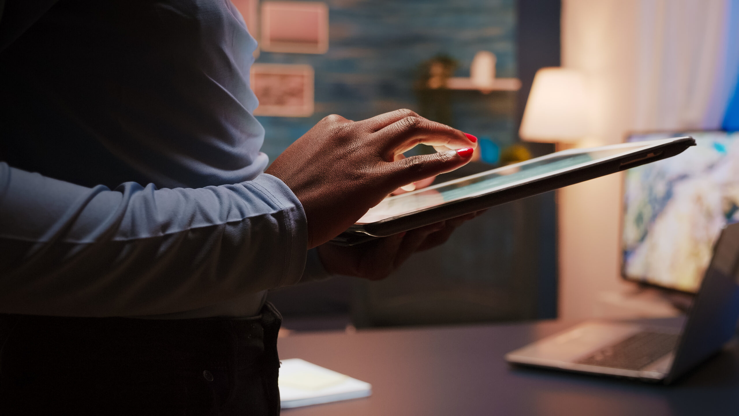 close-up-photo-black-female-hands-holding-tablet-computer-standing-living-room-late-night-african-american-woman-using-social-network-texting-blogging-working-overtime-job